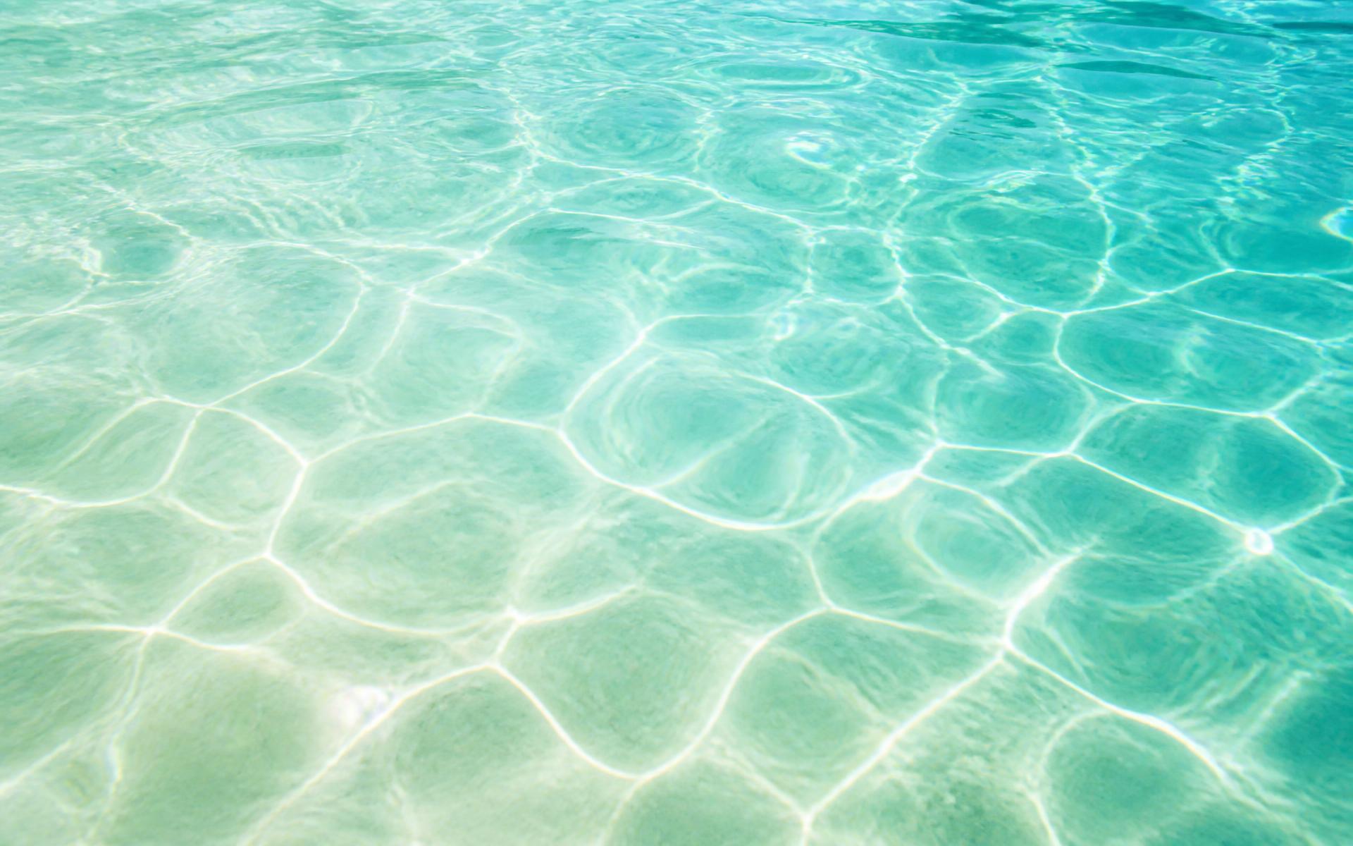 Sunlit therapeutic pool water with soft ripples